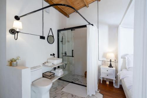 a white bathroom with a shower and a sink at Su Jiu Apartment in Nanning