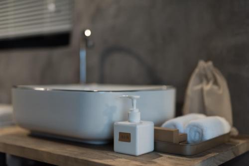 a bathroom sink with a soap dispenser on a counter at Su Jiu Apartment in Nanning