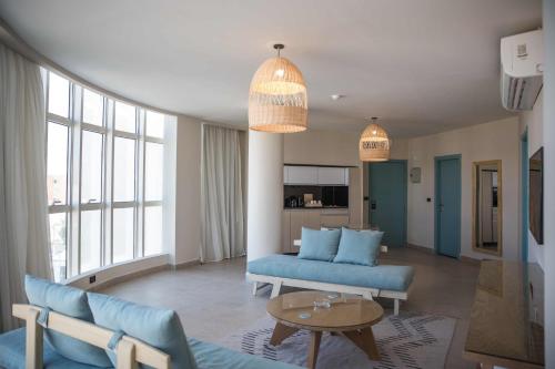 a living room with a blue couch and a table at Redcon Suites in Hurghada