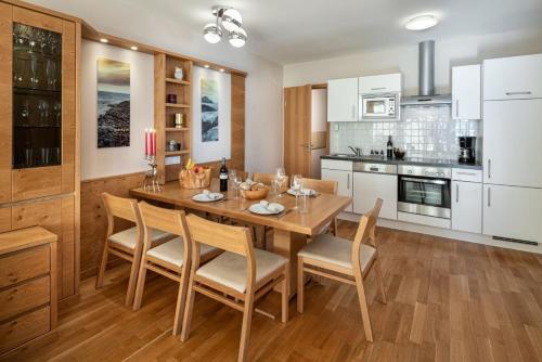 a dining room with a wooden table and chairs at Fewo-Obertauern-Steinadler in Obertauern