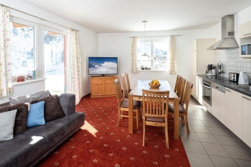 a kitchen and living room with a table and a couch at Fewo-Obertauern-Freja in Obertauern