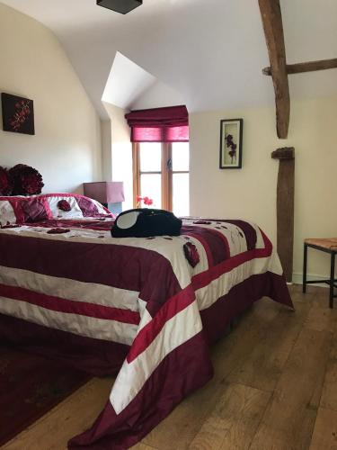 a bedroom with two beds with red and white blankets at Peacock Cottage, Coity Bach in Talybont