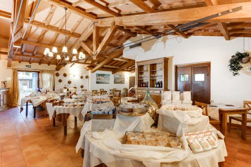 a large room with tables and chairs in it at Borgo Magliano Resort in Magliano in Toscana