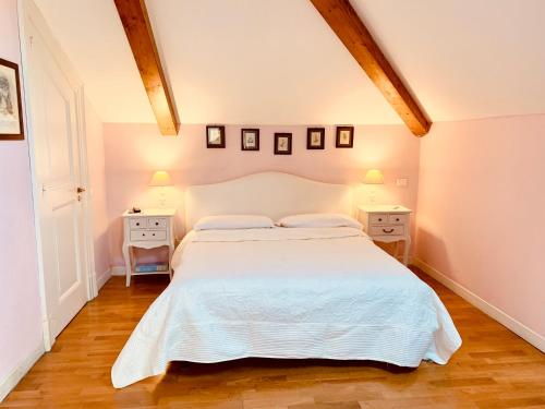 a bedroom with a white bed and two night stands at The Secret Garden Relais in Piano di Sorrento