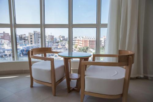 a table and two chairs in a room with a window at Redcon Suites in Hurghada
