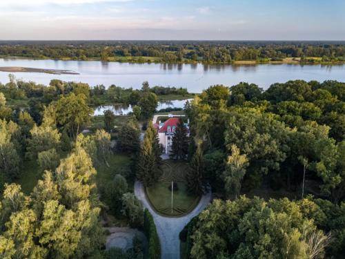 an aerial view of a house on a lake at Pałac w Smoszewie in Smoszewo