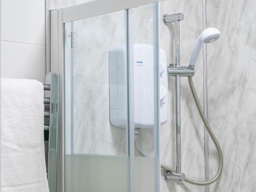 a shower with a hair dryer in a bathroom at Pass the Keys - Bright & Airy 2BR 2Bath Apt in Perfect Location in Belfast