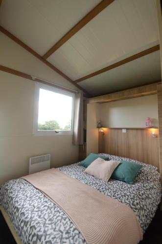 a large bed in a room with a window at la ferme des epis in Ouffières