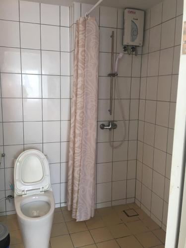 a bathroom with a toilet and a shower stall at Grandbeach Condo Sea view by malai in Mae Pim