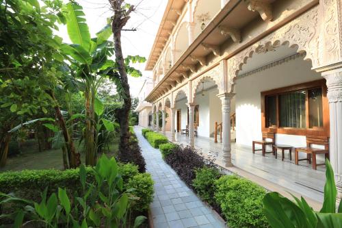 a courtyard of a building with trees and plants at Hotel Sunbird in Bharatpur