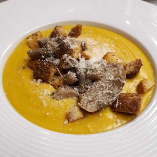 a white bowl of soup with food in it at Agriturismo Ai Carpini in Marcon