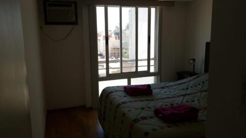a bedroom with a bed and a large window at Parana in Rosario