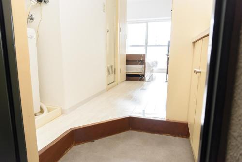 a room with a hallway with a door and a floor at COCOSTAY Global Noboricho4F ココステイ グローバル ノボリチョウ4F in Hiroshima