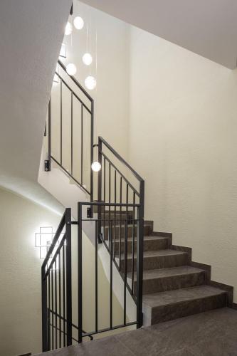 a staircase with black railings in a building at Hotel-Gasthof Höttl in Deggendorf