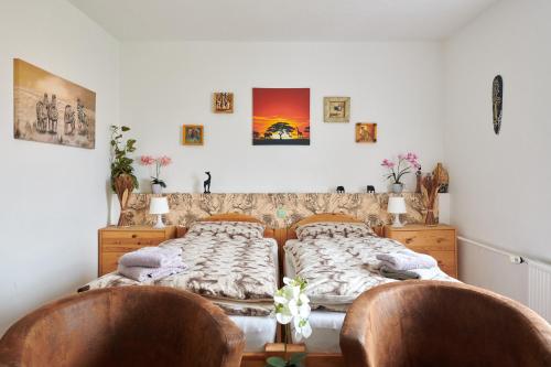 a bedroom with two beds and two chairs at Hüblers-Schlafquartier in Fürstenwalde