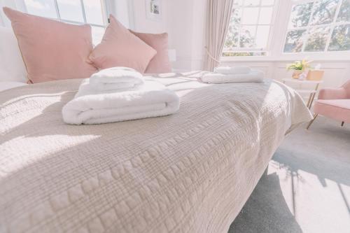a white bed with towels on top of it at Old Bank Rooms in Bourton on the Water