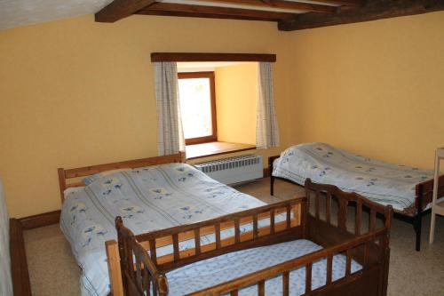 a bedroom with two bunk beds and a window at La Métairie in Houffalize