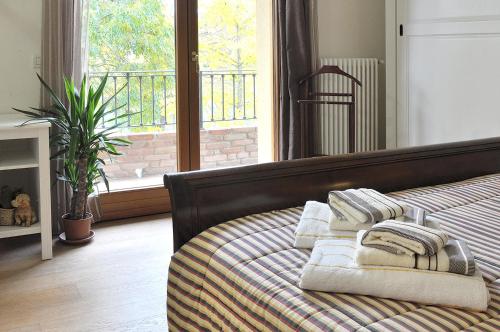 a bedroom with a bed with towels on it at B&B Antico Sentiero in Cesena