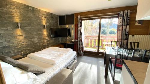 a hotel room with two beds and a window at Hôtel Rent in Megève
