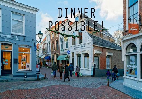 a group of people walking down a city street at de Zeeuwse Hemel in Zierikzee