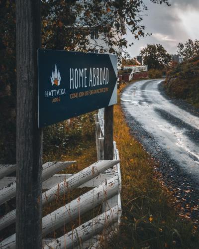 a sign on a fence next to a road at Hattvika Lodge in Ballstad