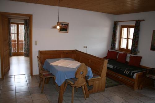 a room with a bed and a table and a couch at Zaissererhof in Brannenburg