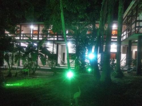 a building with green lights in front of it at night at Pousada Portal do Sol in Itacaré