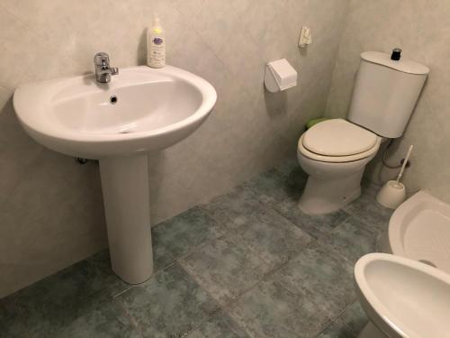 a bathroom with a sink and a toilet at Don Pasqualino in Floridia