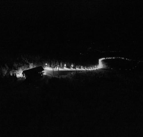 a black and white photo of a road at night at Ski&Sun Apartamenty in Świeradów-Zdrój