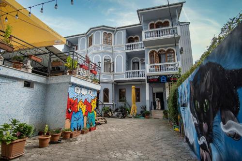 a building with paintings on the side of it at Sweet Home at Ninoshvili 3 in Batumi