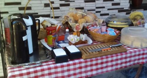 a picnic table with a red and white checkered table cloth at Pousada do Chileno in Praia Grande