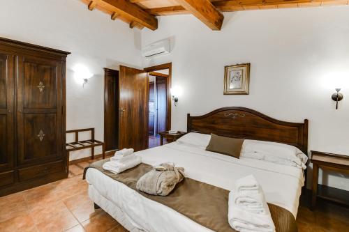 En eller flere senger på et rom på Borgo Magliano Resort