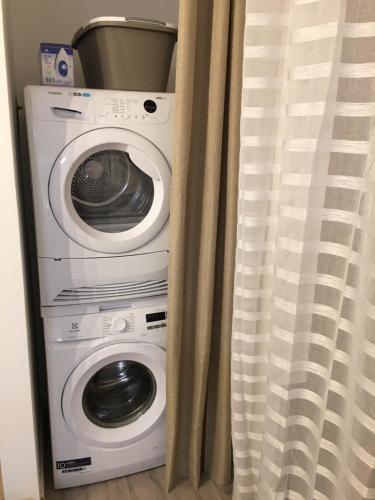 a washer and dryer sitting next to a curtain at Residenza Conte Manetti in Mira