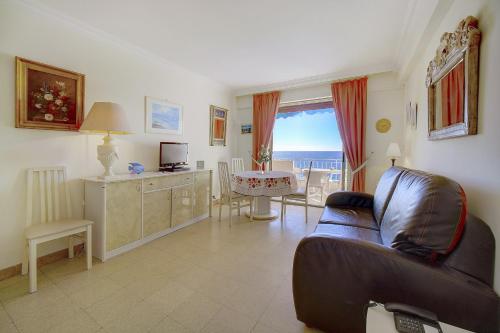 un salon avec un canapé et une table dans l'établissement IMMOGROOM- Sea view - Center- AC- Front of the beaches, à Cannes