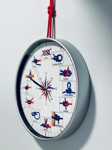 a clock is hanging on a white wall at Thruster - Rooms, Kitchen, Chill-Out Zone-Netflix, Lobby-Netflix in Gdynia
