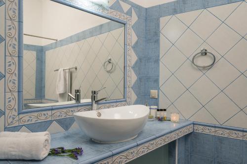 a bathroom with a white sink and a mirror at Casa Belvedere Apartments in Kournás