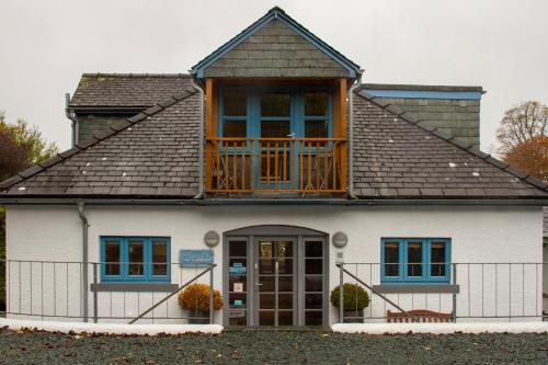 a house with a balcony on top of it at The Lookout Keswick in Keswick