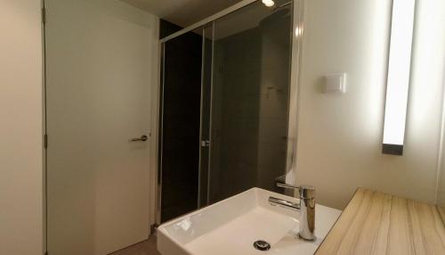 a bathroom with a sink and a shower at Flag Hotel Caldas da Rainha in Caldas da Rainha