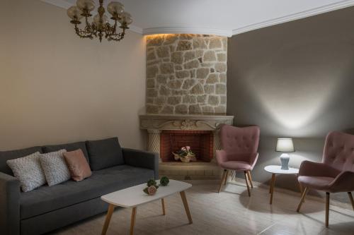 a living room with a couch and a fireplace at Casa Belvedere Apartments in Kournás