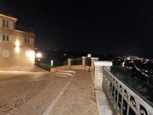 a night view of a building with a walkway at La Casa Di Torre Di Palme in Marina Palmense