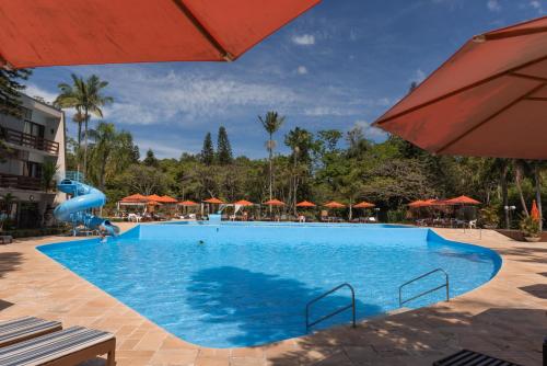 a pool at a resort with a water slide at Hotel Internacional Gravatal in Gravatal