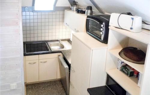 a small kitchen with a microwave and a sink at Ferienhaus 15 In Kirchheim in Kirchheim