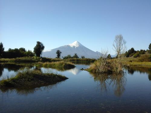 a mountain in the distance with a lake in the foreground at Topahue in Ensenada