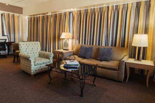 a living room with a couch and a coffee table at Stamford Suites in Stamford