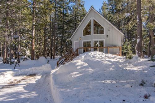 a house with a pile of snow around it at Poma Lane in Soda Springs
