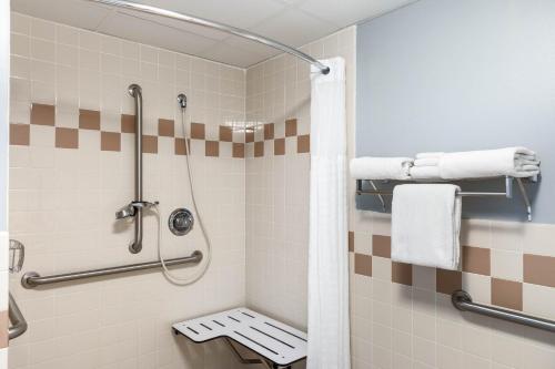 uma casa de banho com um chuveiro com um banco em AmericInn by Wyndham Jackson em Jackson