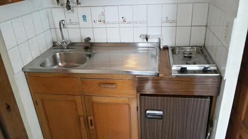 a small kitchen with a sink and a stove at Lodging Quirinal in El Tabo