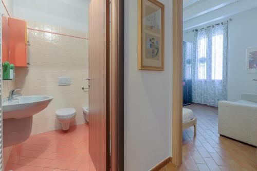 a bathroom with a toilet and a sink at Dimora Tipica Ferrarese in Ferrara