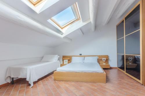 a bedroom with a bed and a skylight at Dimora Tipica Ferrarese in Ferrara