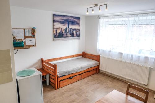 a small room with a bed and a window at Vila Alice in Luhačovice